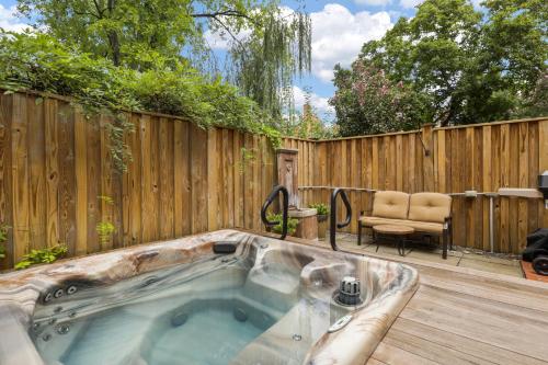 a hot tub in a backyard with a wooden fence at The Nostalgic of Old Town in Alexandria