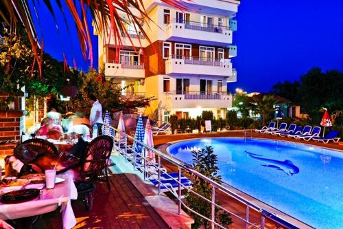 a resort with a swimming pool and a hotel at Irem Garden Hotel & Apartments in Side