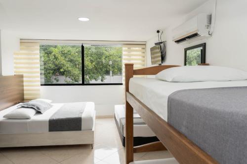 Postel nebo postele na pokoji v ubytování Hotel Palo Alto Laureles