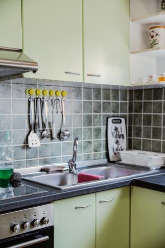 a kitchen with a sink and a stove at Bejart Apartment 3 in Tirana