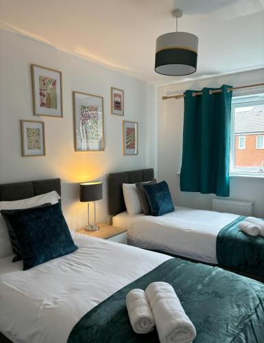 a bedroom with two beds and a living room at Delight Marvel-Waltham Place - Ashford in Ashford