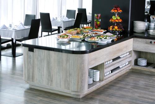 a buffet with plates of food on a table at Wyndham Bogota in Bogotá