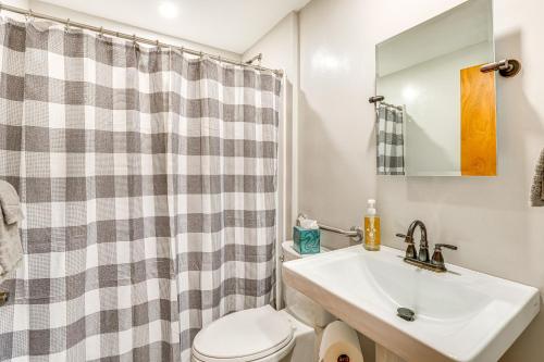 a bathroom with a sink and a toilet and a shower at Okee Bay House on Lake Wisconsin with Private Dock! in Lodi