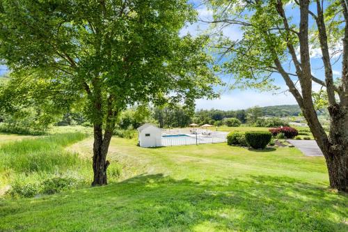 a white barn in a field with trees at Best Western - Freeport Inn in Freeport
