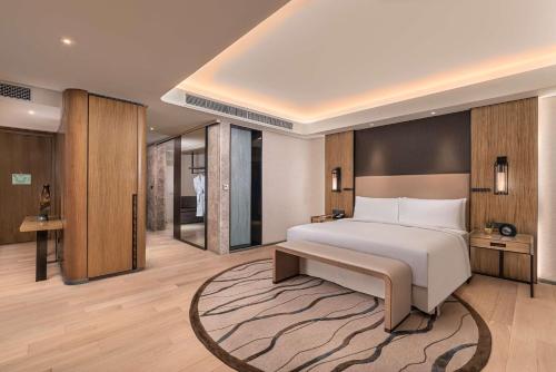 a bedroom with a large bed and a rug at Conrad Manila in Manila