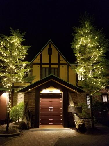 a church with a garage with a cross on the top at Dormy Club Karuizawa in Karuizawa