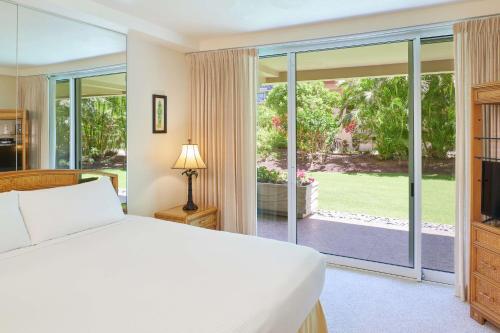 a bedroom with a bed and a large window at Aston at The Whaler on Kaanapali Beach in Lahaina