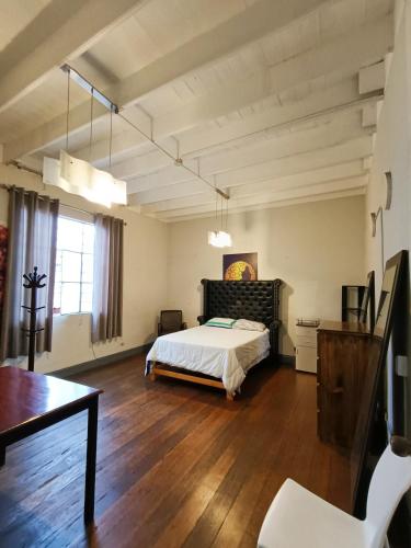 a large bedroom with a bed and a wooden floor at Casa Turística Monumental in Lima