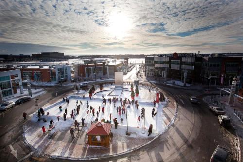 a group of people on an ice rink in a city at Holiday Inn Laval Montreal by IHG in Laval