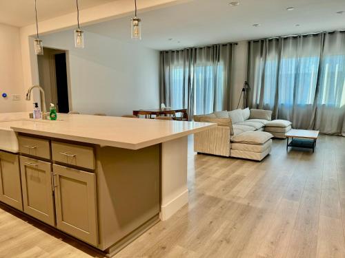 a kitchen and living room with a large island at Spacious new house in Folsom Ranch 4BD and 3BA with backyard and BBQ grill in Folsom