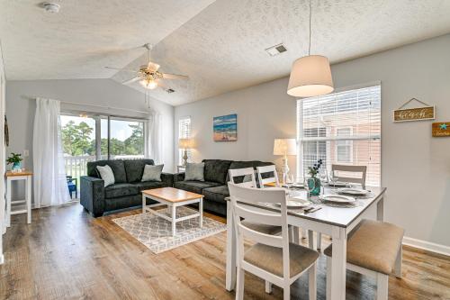 a dining room and living room with a table and chairs at Resort Amenity Access Chic Myrtle Beach Condo! in Myrtle Beach