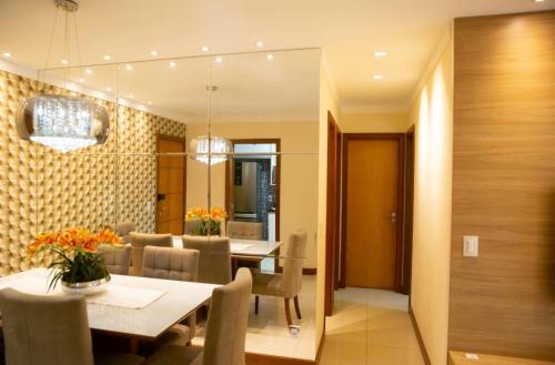 a dining room with a table and chairs at Apartamento Beira Mar em Praia de Itaparica - Vila Velha- ES in Itaparica