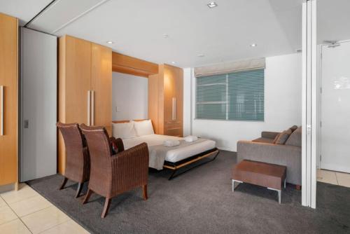 a hotel room with a bed and a couch at Waimahana Apartment 4 in Taupo