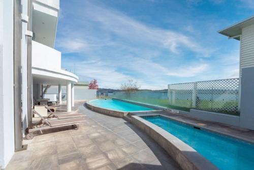 a swimming pool on the side of a house at Waimahana Apartment 4 in Taupo