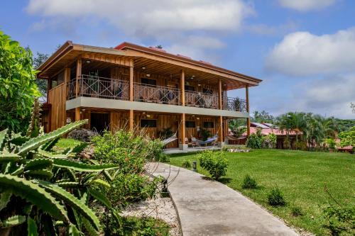 a house with a pathway leading up to it at Hacienda Guachipelin Volcano Ranch Hotel & Hot Springs in Liberia