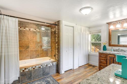 a bathroom with a shower and a tub and a sink at Rexburg Escape with Fenced Yard and Covered Patio! in Rexburg
