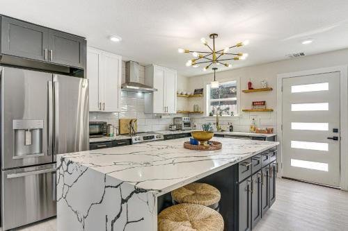a kitchen with a marble counter top and a refrigerator at Less Than 1 Mi to Sea! Family and Pet-Friendly Galveston Gem in Galveston