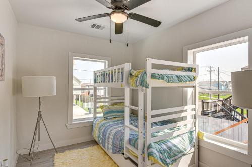 a bedroom with a bunk bed and a ceiling fan at Less Than 1 Mi to Sea! Family and Pet-Friendly Galveston Gem in Galveston