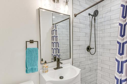 a bathroom with a sink and a shower at Less Than 1 Mi to Sea! Family and Pet-Friendly Galveston Gem in Galveston
