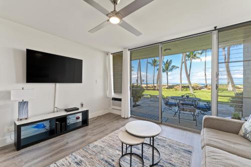 a living room with a couch and a tv at Hale Kai O'Kihei 120 in Kihei