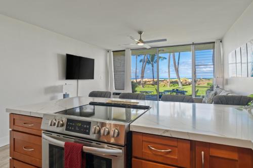 a kitchen with a stove and a counter top at Hale Kai O'Kihei 120 in Kihei