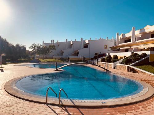 a swimming pool in the middle of a resort at Vila Rafaella - Praia de São Rafael in Sesmarias
