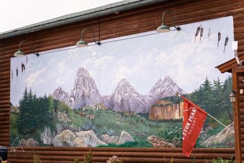 a mural on the side of a building with a flag at Teton Peaks Resort in Tetonia