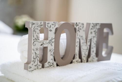 a mug with the word love sitting on a bed at Apartamento vacacional HM Home Yeste in Yeste