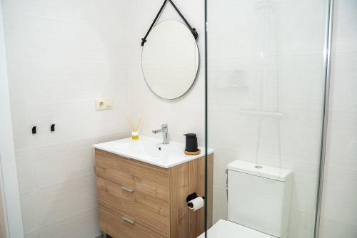 a bathroom with a toilet and a sink and a mirror at Apartamento vacacional HM Home Yeste in Yeste