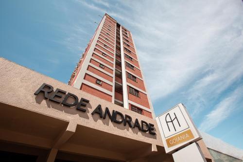 a building with a sign on top of a store at Rede Andrade Goiania Centro in Goiânia