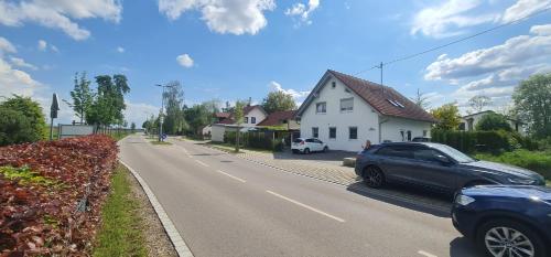 a car parked on the side of a road next to a house at Ferienwohnung Illertal in Unteropfingen
