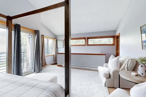 a bedroom with a bed and a couch at Lakeview Townhome Unit A5 in Avon