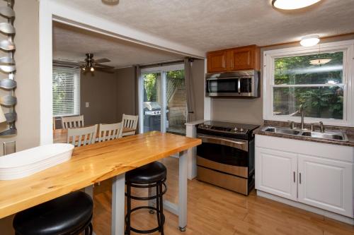 a kitchen with a wooden table and a counter top at Cottage Near Cedar Point & Beach in Huron