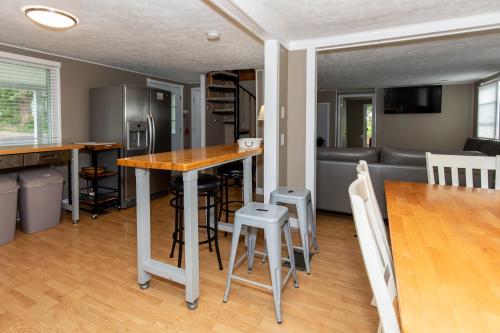 a kitchen and living room with a table and chairs at Cottage Near Cedar Point & Beach in Huron