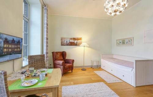 a room with a bed and a table and a chair at Gorgeous Apartment In Krakow Am See in Krakow am See