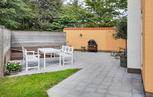 a patio with two chairs and a table and a grill at Amazing Home In Skagen With Wifi in Skagen