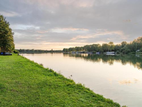 a river with cars parked on the side at Forest-View Mansion, Hainaut in Antoing