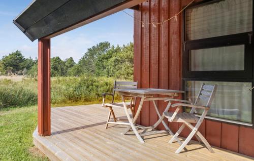 a wooden deck with a table and chairs on it at 2 Bedroom Amazing Home In Skagen in Skagen