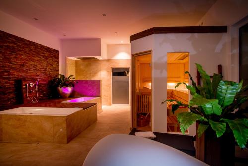 a kitchen with a large tub in a room at Hotel Restaurant Kohlbrecher Villeroy & Boch SPA in Osnabrück