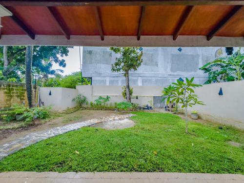 a view of a garden from the outside of a building at Bungalow By Tropical Villa in Weligama