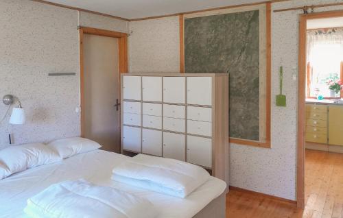 a bedroom with a white bed and a window at 1 Bedroom Beautiful Home In Älmhult in Älmhult