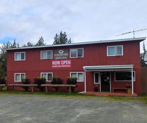 a red building with a new open sign on it at The Hibernation Station in Sterling