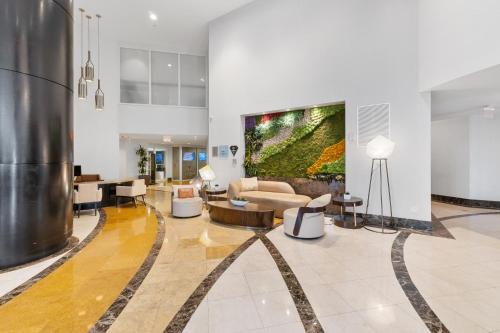 a living room with a large painting on the wall at Lujoso apartamento en playa de Sunny Isles Beach in Sunny Isles Beach