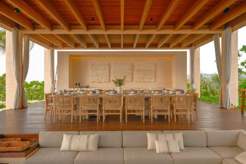 a large dining room with a long table and chairs at ONTO House Puerto Escondido in Tlachicón