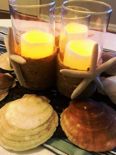 a table with two candles and some bread and biscuits at Historic district water viewprivate parking 3 cars in Wilmington