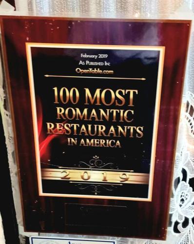 a sign for a most romantic restaurants in americoria at Historic district water viewprivate parking 3 cars in Wilmington