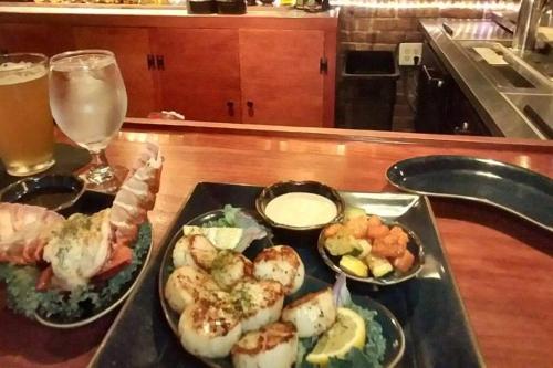 a tray with two plates of food and a glass of beer at Historic district water viewprivate parking 3 cars in Wilmington