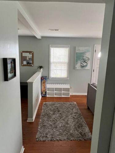 a living room with a staircase and a rug at Historic district water viewprivate parking 3 cars in Wilmington