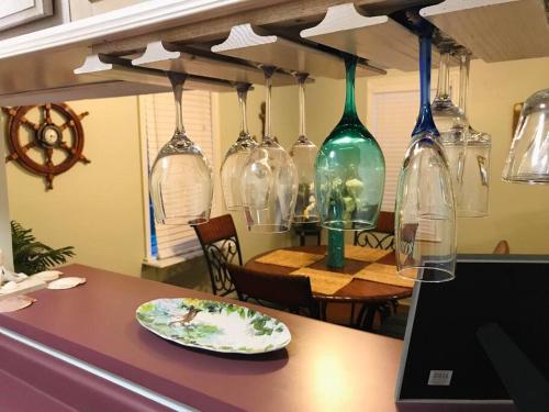 a table with a laptop and many glass bottles on it at Historic district water viewprivate parking 3 cars in Wilmington