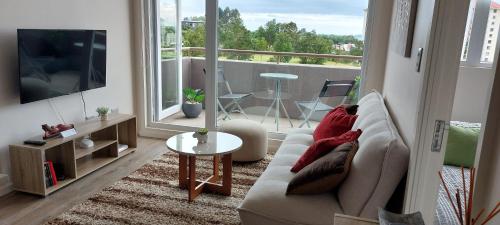a living room with a couch and a table at Departamento con vista al mar en Puerto Montt in Puerto Montt